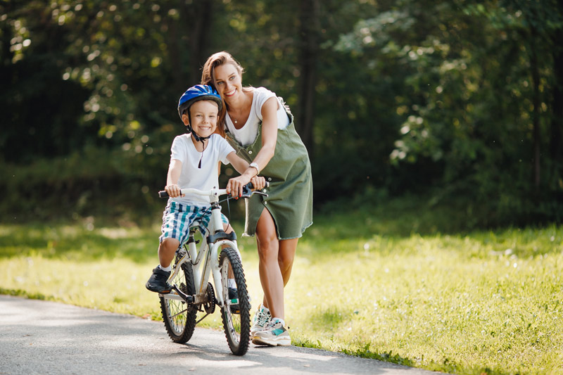 A woman with a child, riding a bike